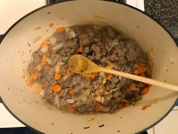 Cooked Italian sausage with carrots and onions and garlic