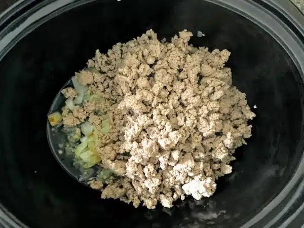Browned ground turkey in slow cooker with onions