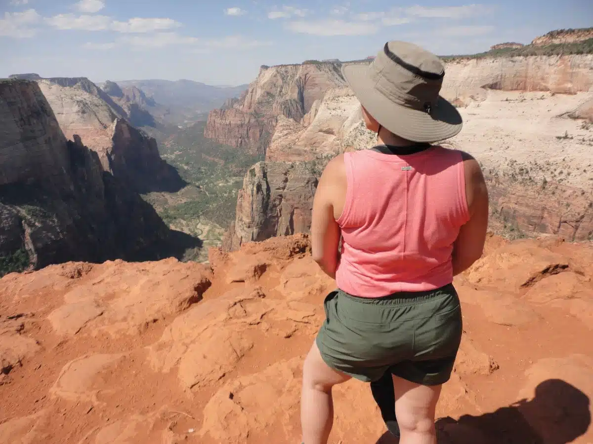 woman overlooking view of zion canyon from observation point