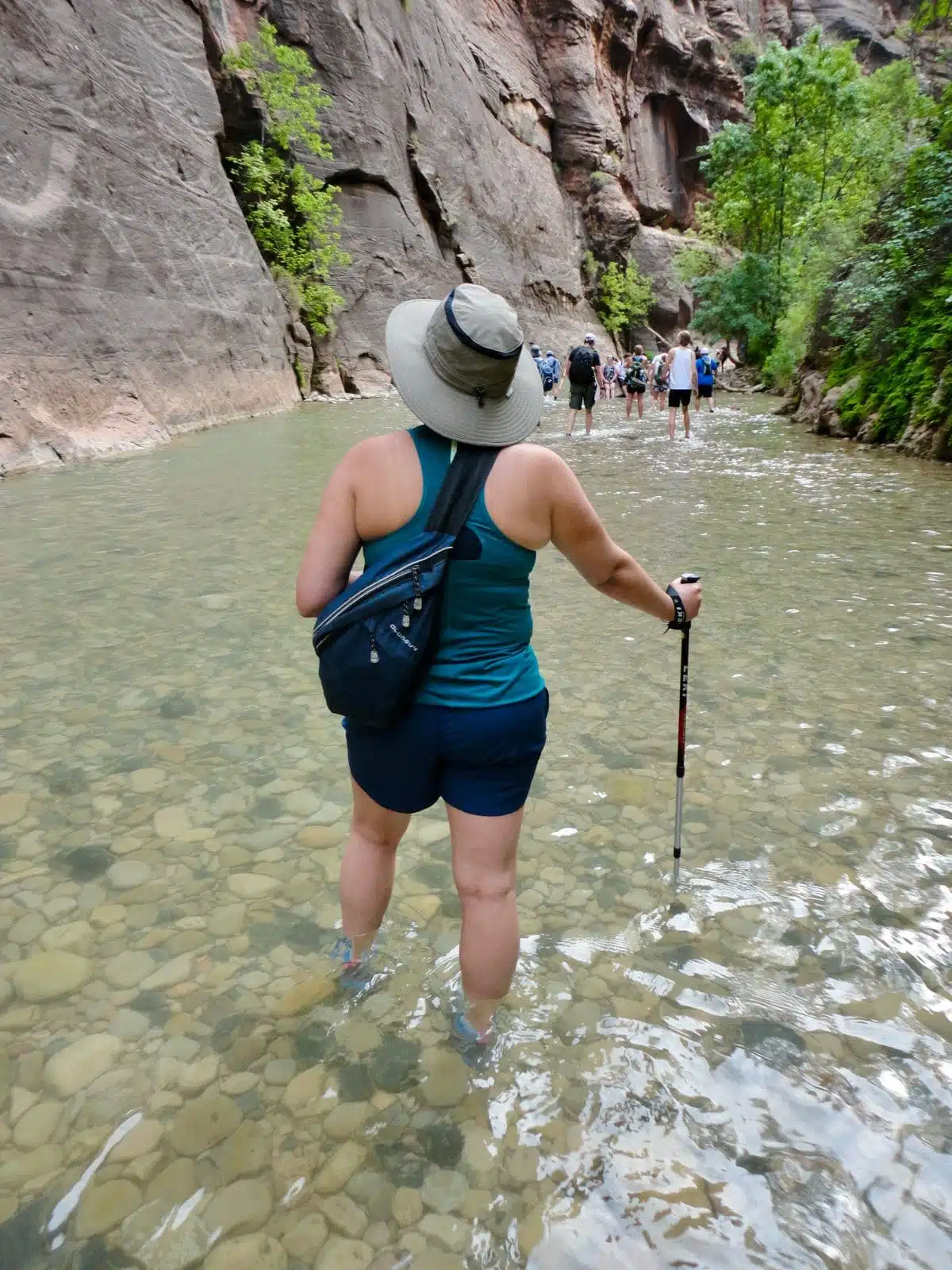 best hiking trails in zion national park, people walking in the shallow waters of the Virgin River
