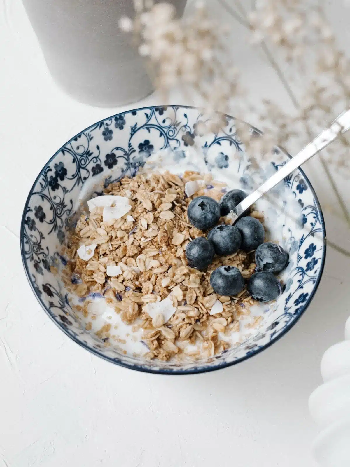 bowl of oatmeal with a few blueberries on top