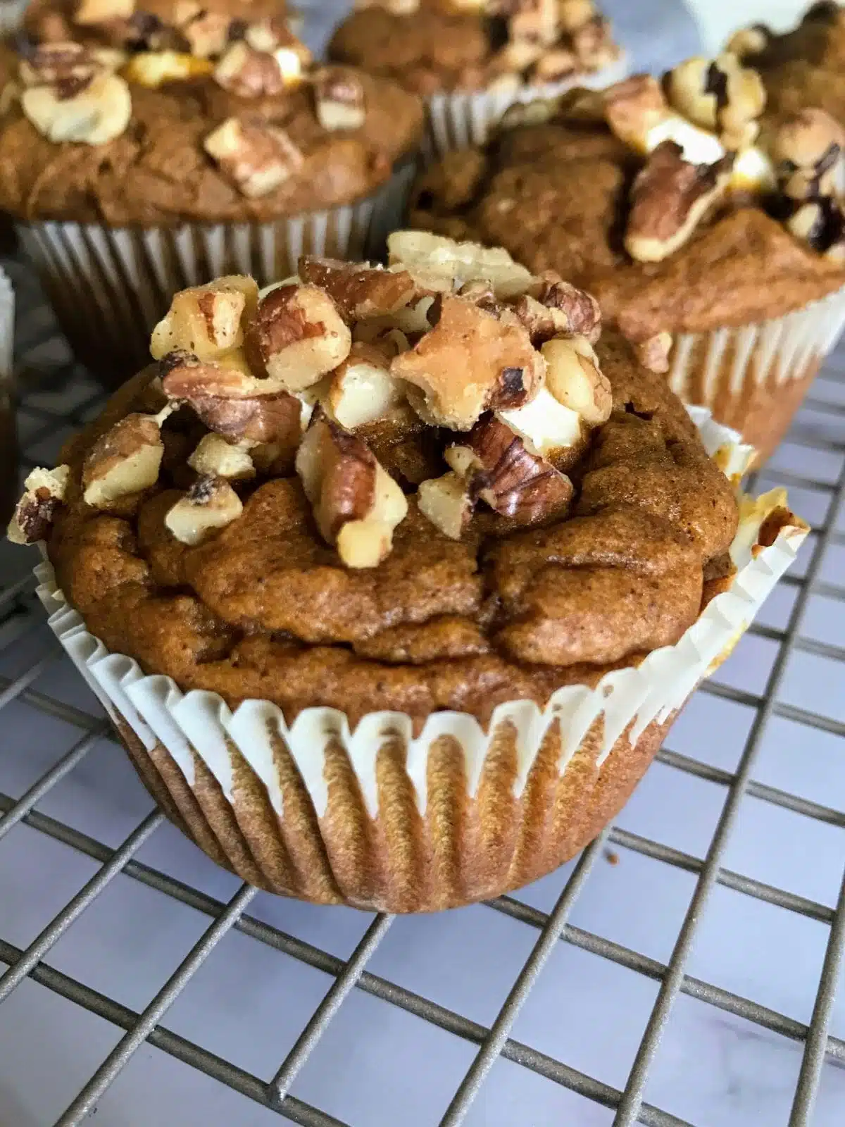 healthy pumpkin cream cheese muffins on a wire rack