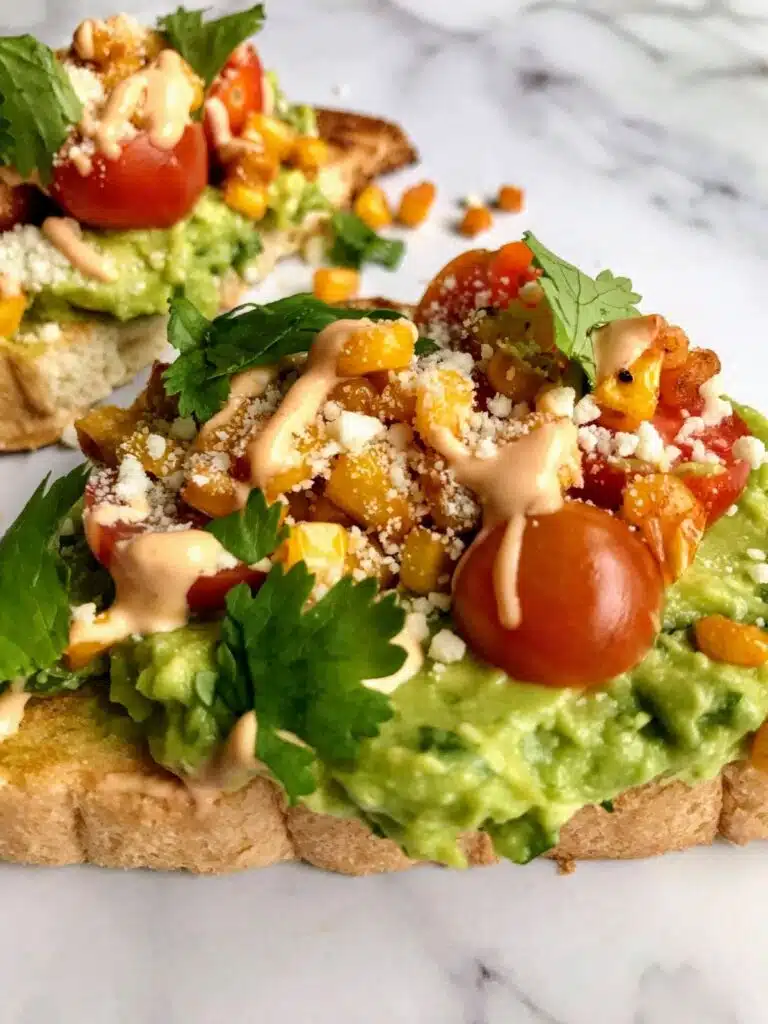 avocado toast with tomatoes, corn, cilantro, and chipotle aioli