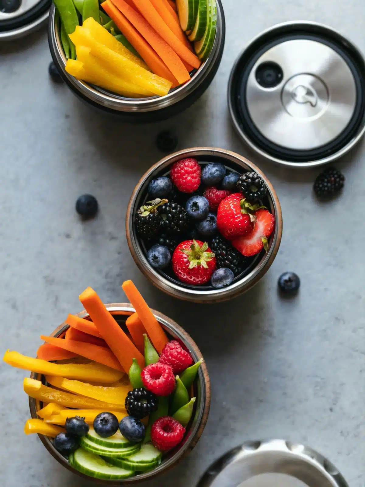 containers of berries and raw vegetables.