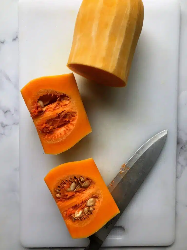 squash cut in half on a cutting board.