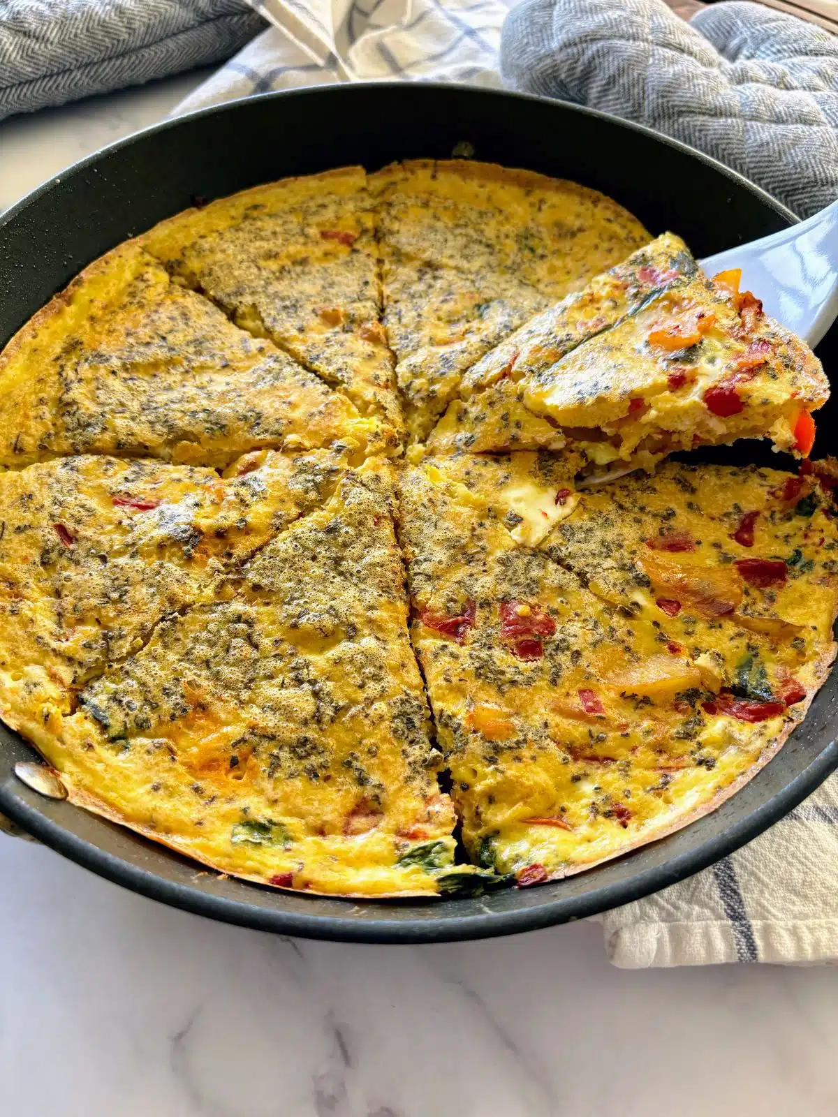 Dairy-free frittata with red bell pepper and spinach.
