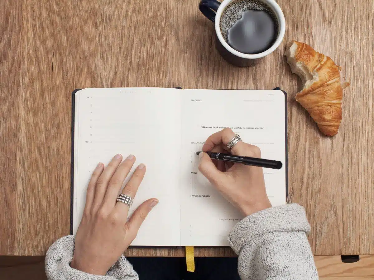 person writing in a diary.