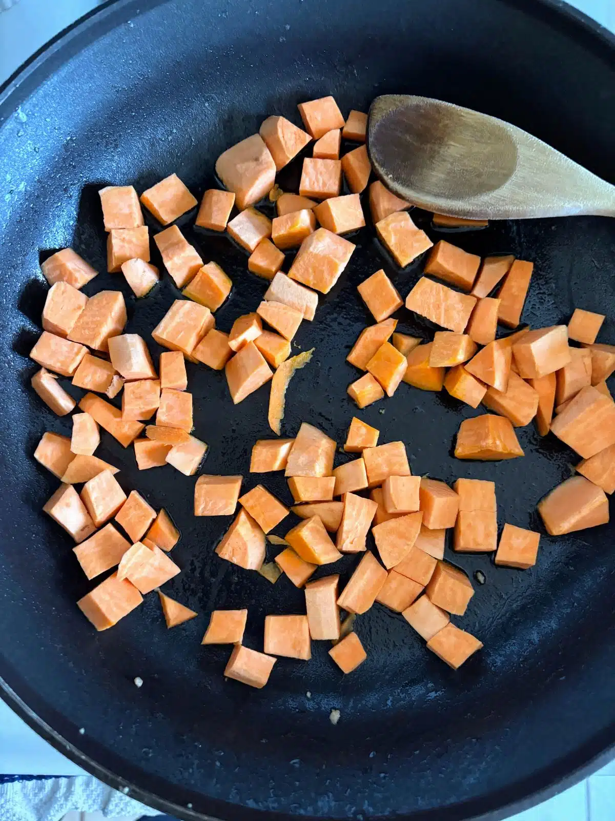 Diced sweet potato in a skillet.