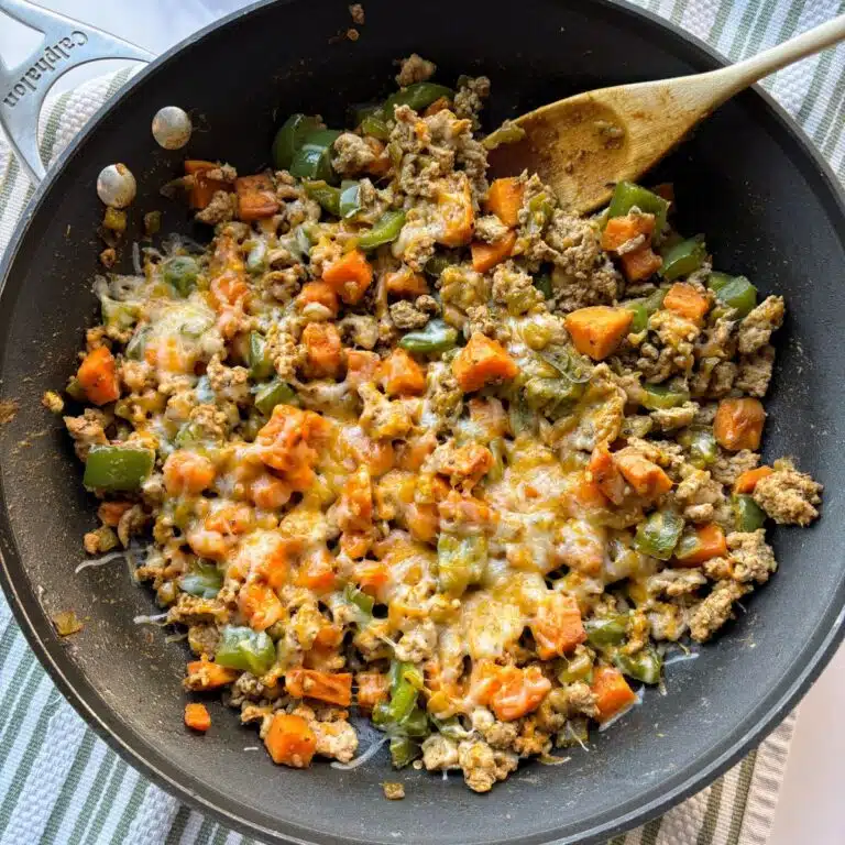 Ground turkey sweet potato skillet covered with melted cheese.